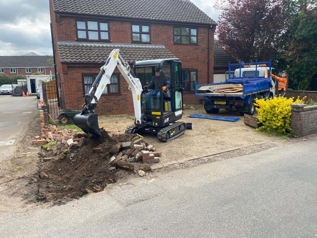 This is a photo of an operative of Harleston Driveway Installers Digging out for a new tarmac driveway